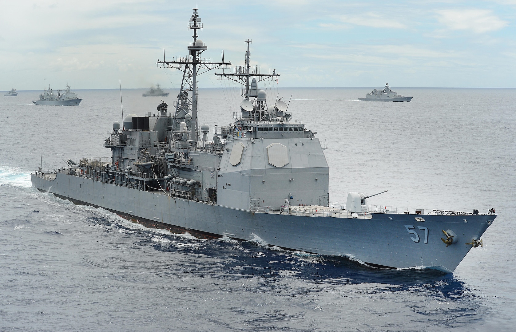 140725-N-FC670-226 PACIFIC OCEAN (July 25, 2014) The guided-missile cruiser USS Lake Champlain (CG 57) underway in close formation as one of forty-two ships and submarines representing 15 international partner nations during Rim of the Pacific (RIMPAC) 2014. Champlain is currently conducting live-fire testing off the coast of California with its 5-inch guns to verify the new mode on the SPQ-9B while the crew undergoes operator training to ensure proficiency with the new capability. (U.S. Navy photo by Mass Communication Specialist 1st Class Shannon Renfroe/Released)