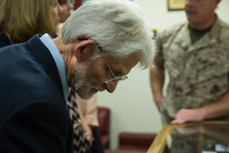 Charles Marty, nephew of Staff Sgt. Jacob Marty, a Marine killed in action during World War II, views a display case in Marine Air Control Group (MACG) 38’s heritage room aboard Marine Corps Air Station Miramar, Calif., March 16. Staff Sgt. Jacob Marty served with Air Warning Squadron (AWS) 1, a unit that was affiliated with MACG-38, and was the first Marine killed in action who was associated that was ith the unit. (U.S. Marine Corps photo by Sgt. Lillian Stephens/Released)