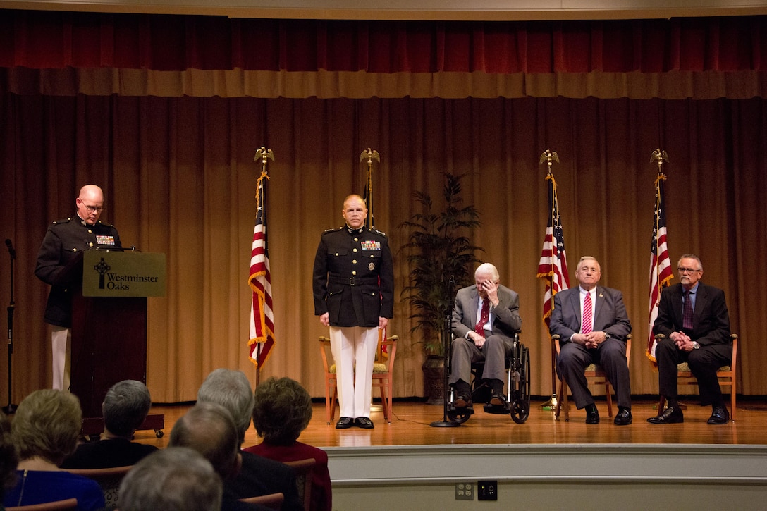 Commandant of the Marine Corps Gen. Robert B. Neller, stands at attention during an award ceremony at Tallahassee, Fla., March 18, 2016. Neller presented retired U.S. Marine Lt. Gen. Lawrence F. Snowden, an Iwo Jima veteran, with the Department of Defense Medal for Distinguished Public Service and Navy Distinguished Public Service Award. (U.S. Marine Corps photo by Staff Sgt. Gabriela Garcia/Released)