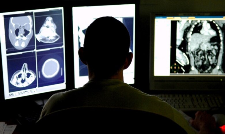 BALAD AIR BASE, Iraq -- Maj. Michael Matchette, 332nd Expeditionary Medical Support Squadron radiologist, reviews CT scans from a trauma patient to determine the severity of the injuries at the Air Force Theater Hospital here, Feb. 20. The CT scan process goes directly from the scanning machine to the computer, which allows doctors to diagnose medical problems faster. Major Matchette is deployed from Lackland Air Force Base, Texas. (U.S. Air Force photo by/ Senior Airman Julianne Showalter)