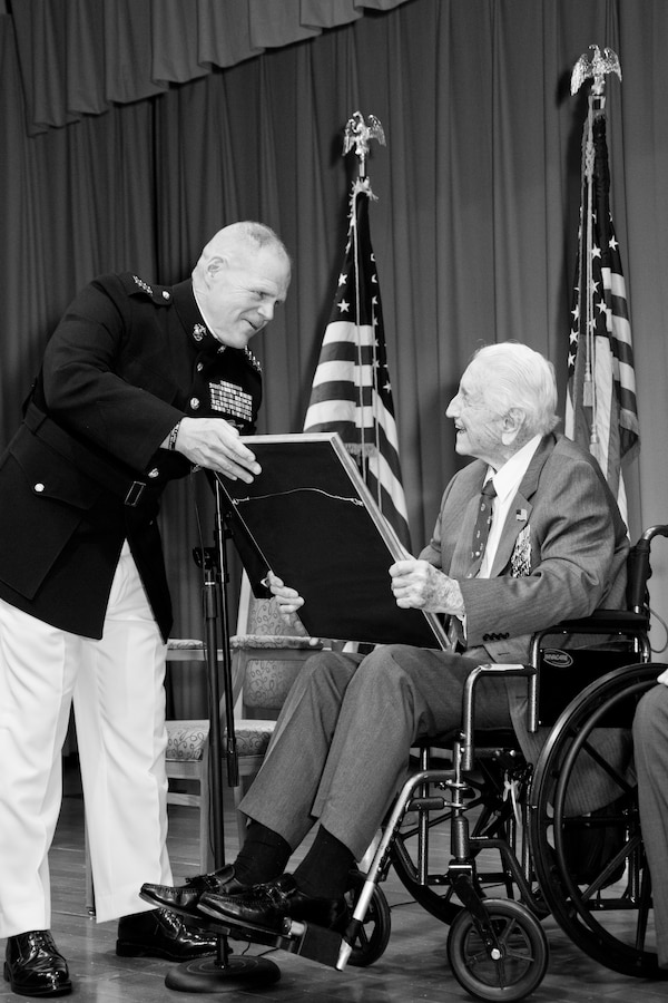 Commandant of the Marine Corps Gen. Robert B. Neller, left, presents an award to retired U.S. Marine Lt. Gen. Lawrence F. Snowden, an Iwo Jima veteran, at Tallahassee, Fla., March 18, 2016. Neller presented Snowden with the Department of Defense Medal for Distinguished Public Service and Navy Distinguished Public Service Award. (U.S. Marine Corps photo illustration by Staff Sgt. Gabriela Garcia/Released)