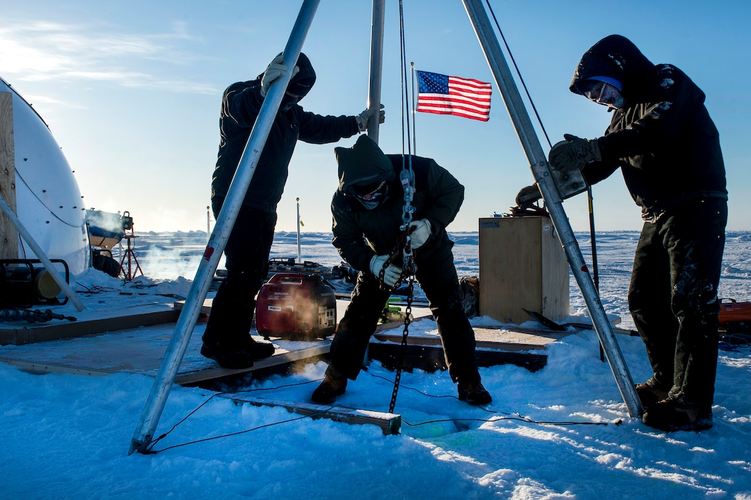 Engineers with the Applied Physics Lab create a hole in nine feet of ice to deploy divers during Ice Exercise 2016 at Ice Camp Sargo, Arctic Circle, March 8, 2016. Navy photo by Petty Officer 2nd Class Tyler N. Thompson