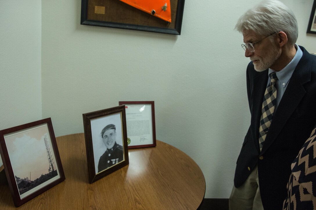 Charles Marty, nephew of Staff Sgt. Jacob Marty, observes a photograph of his uncle in the heritage room of Marine Air Control Group (MACG) 38 aboard Marine Corps Air Station Miramar, Calif., March 16. Jacob Marty served with Air Warning Squadron (AWS) 1, a unit that was affiliated with MACG-38, and was the first Marine killed in action who was associated with the unit. (U.S. Marine Corps photo by Sgt. Lillian Stephens/Released)