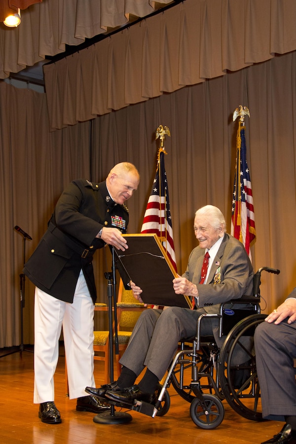 Commandant of the Marine Corps Gen. Robert B. Neller, left, presents an award to retired U.S. Marine Lt. Gen. Lawrence F. Snowden, an Iwo Jima veteran, at Tallahassee, Fla., March 18, 2016. Neller presented Snowden with the Department of Defense Medal for Distinguished Public Service and Navy Distinguished Public Service Award. (U.S. Marine Corps photo by Staff Sgt. Gabriela Garcia/Released)