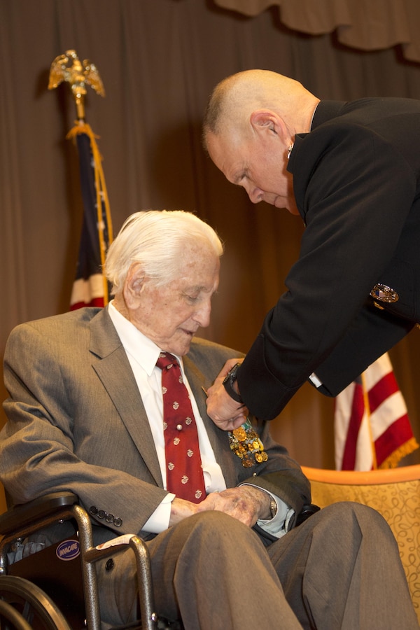 Commandant of the Marine Corps Gen. Robert B. Neller, right, presents an award to retired U.S. Marine Lt. Gen. Lawrence F. Snowden, an Iwo Jima veteran, at Tallahassee, Fla., March 18, 2016. Neller presented Snowden with the Department of Defense Medal for Distinguished Public Service and Navy Distinguished Public Service Award. (U.S. Marine Corps photo by Staff Sgt. Gabriela Garcia/Released)