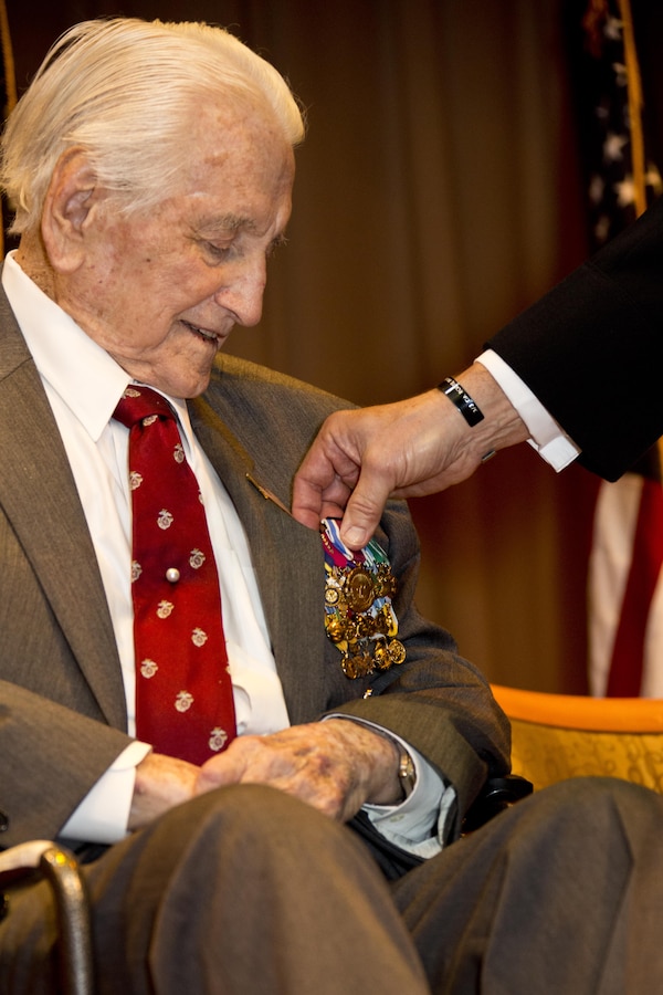 Commandant of the Marine Corps Gen. Robert B. Neller, right, presents an award to retired U.S. Marine Lt. Gen. Lawrence F. Snowden, an Iwo Jima veteran, at Tallahassee, Fla., March 18, 2016. Neller presented Snowden with the Department of Defense Medal for Distinguished Public Service and Navy Distinguished Public Service Award. (U.S. Marine Corps photo by Staff Sgt. Gabriela Garcia/Released)