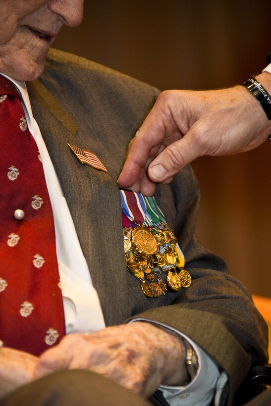 Commandant of the Marine Corps Gen. Robert B. Neller, right, presents an award to retired U.S. Marine Lt. Gen. Lawrence F. Snowden, an Iwo Jima veteran, at Tallahassee, Fla., March 18, 2016. Neller presented Snowden with the Department of Defense Medal for Distinguished Public Service and Navy Distinguished Public Service Award. (U.S. Marine Corps photo by Staff Sgt. Gabriela Garcia/Released)