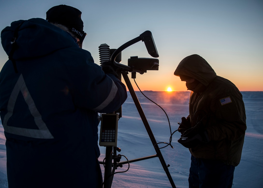 Navy Petty Officer 1st Class Daryl Meer, left, and Navy Petty Officer 2nd Class Zachary Yanez set up an Advanced Automated Weather Observation System during Ice Exercise 2016 at Ice Camp Sargo, Arctic Circle, March 10, 2016. Meer and Yanez are aerographer's mates assigned to the Fleet Weather Center Norfolk. Navy photo by Petty Officer 2nd Class Tyler N. Thompson