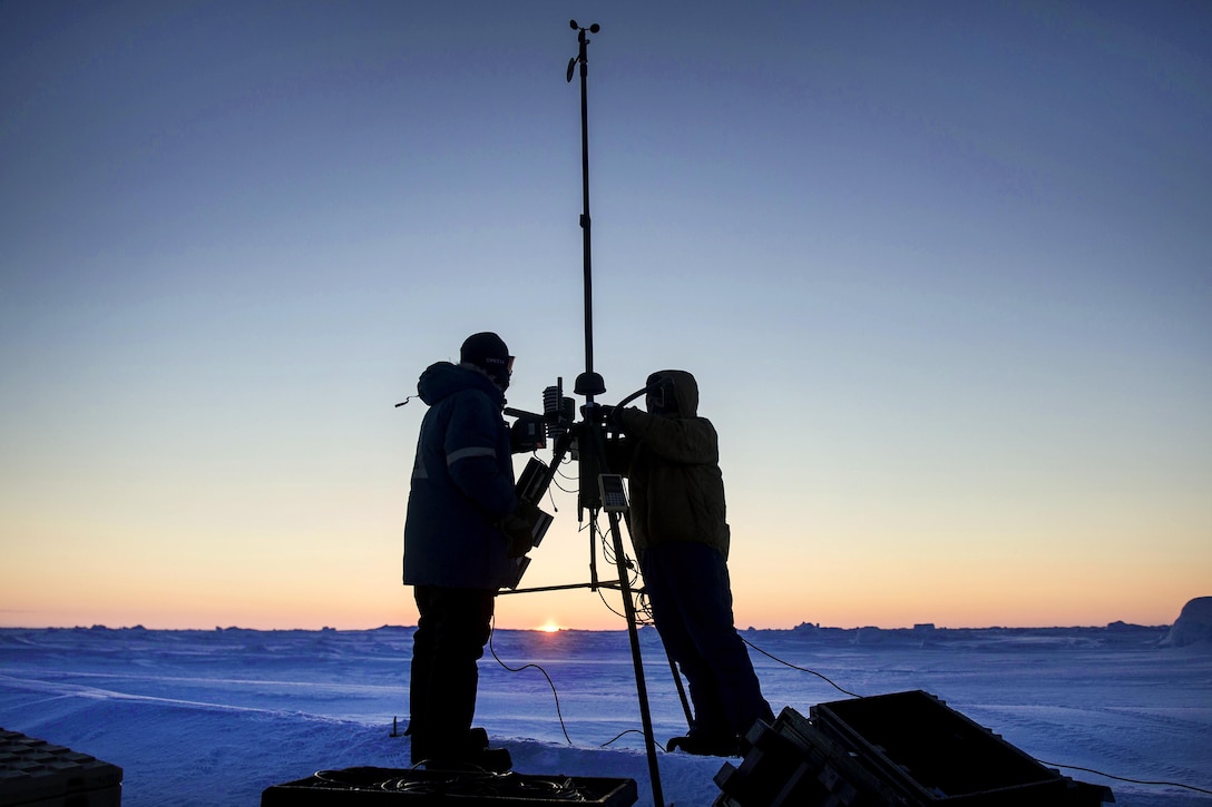 Navy Petty Officer 1st Class Daryl Meer, left, and Navy Petty Officer 2nd Class Zachary Yanez set up an Advanced Automated Weather Observation System during Ice Exercise 2016 at Ice Camp Sargo, Arctic Circle, March 10, 2016. Meer and Yanez are aerographer's mates assigned to the Fleet Weather Center Norfolk. Navy photo by Petty Officer 2nd Class Tyler N. Thompson