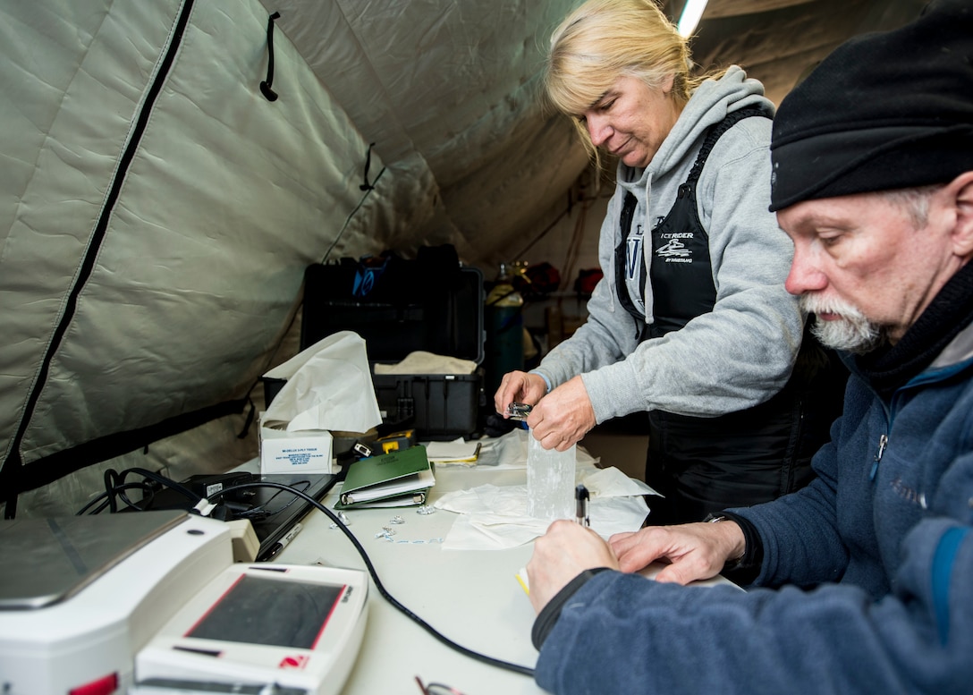 Dr. Joan Gardener, left, and Dr. Rick Hagen, with the Naval Research Lab, measure and weigh an ice core sample taken during Ice Exercise 2016 at Ice Camp Sargo, Arctic Circle, March 10, 2016. Navy photo by Petty Officer 2nd Class Tyler N. Thompson