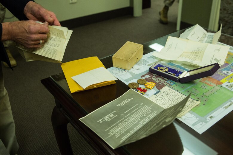 Charles Marty, nephew of Staff Sgt. Jacob Marty, a Marine who was killed in action during World War II, shares official documents, awards and his uncle’s Purple Heart medal with Marines of Marine Air Control Group (MACG) 38 aboard Marine Corps Air Station Miramar, Calif., March 16. Marines with MACG-38 hosted three surviving family members of Staff Sgt. Jacob Marty, the first Marine to be killed in action from Air Warning Squadron (AWS) 1, a unit affiliated with MACG-38. (U.S. Marine Corps photo by Sgt. Lillian Stephens/Released)
