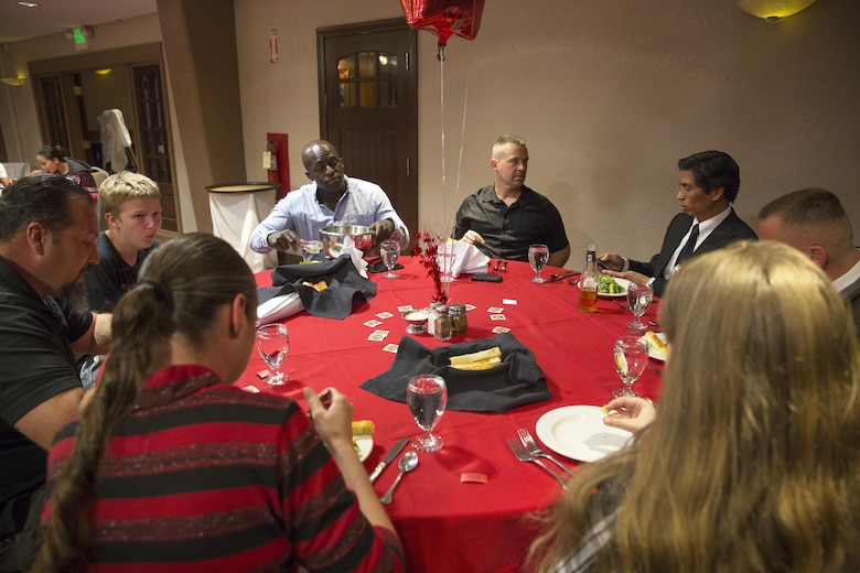 Marines and families with Communication Training Battalion, Marine Corps Communication-Electronics School, enjoy dinner together during the battalion’s first anniversary celebration at the Officer’s Club March 10, 2016. The battalion, activated March 12, 2015, brought the training of enlisted and commissioned communication Marines under one command. (Official Marine Corps photo by Lance Cpl. Levi Schultz/Released)