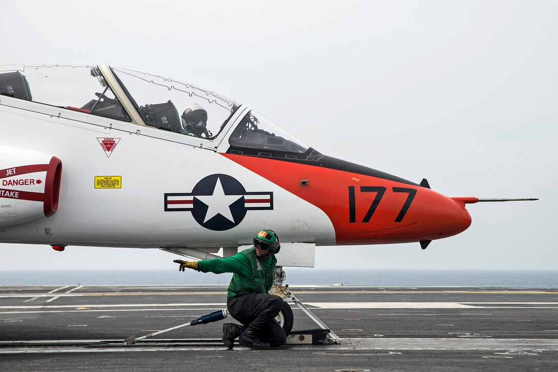 Navy Airman Raheem Malloy clears the catapult to launch a T-45C Goshawk on the flight deck of the aircraft carrier USS George Washington in the Atlantic Ocean, March 17, 2016. The George Washington is conducting carrier qualifications in the Atlantic Ocean. The Goshawk is assigned to Training Air Wing 1. Navy photo by Petty Officer 3rd Class Bryan Mai
