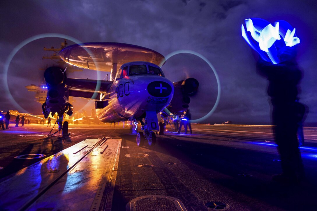 An E-2C Hawkeye performs preflight checks on the flight deck of the aircraft carrier USS Dwight D. Eisenhower in the Atlantic Ocean, March 20, 2016. The Hawkeye is assigned to Airborne Early Warning Squadron123. Navy photo by Petty Officer 3rd Class J. Alexander Delgado