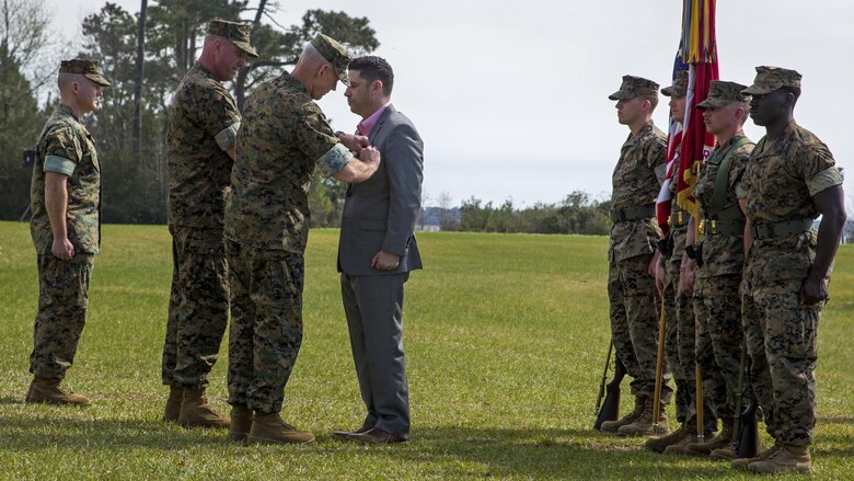 Maj. Gen. Brian Beaudreault, commanding general of 2nd Marine Division, pins a Silver Star Medal on Sgt. Matthew Parker (ret.) at Marine Corps Base Camp Lejeune, North Carolina, March 18, 2016. Parker was awarded the Silver Star for his courageous actions during Operation Enduring Freedom in 2011, where he assumed control of his platoon during a firefight after several leaders had been injured.