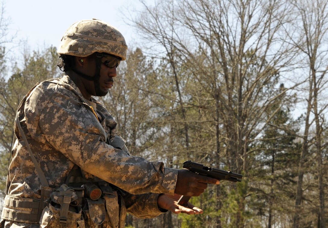 U.S. Army Sgt. Lewis Johnson of Elgin, Ill., a squad leader with the 282nd Quartermaster Company, prepares to fire on the pistol range during the 642nd Regional Support Group's Best Warrior Competition at Fort McClellan, Ala., Feb. 19. (U.S. Army photo by Sgt. 1st Class Gary A. Witte, 642nd Regional Support Group)