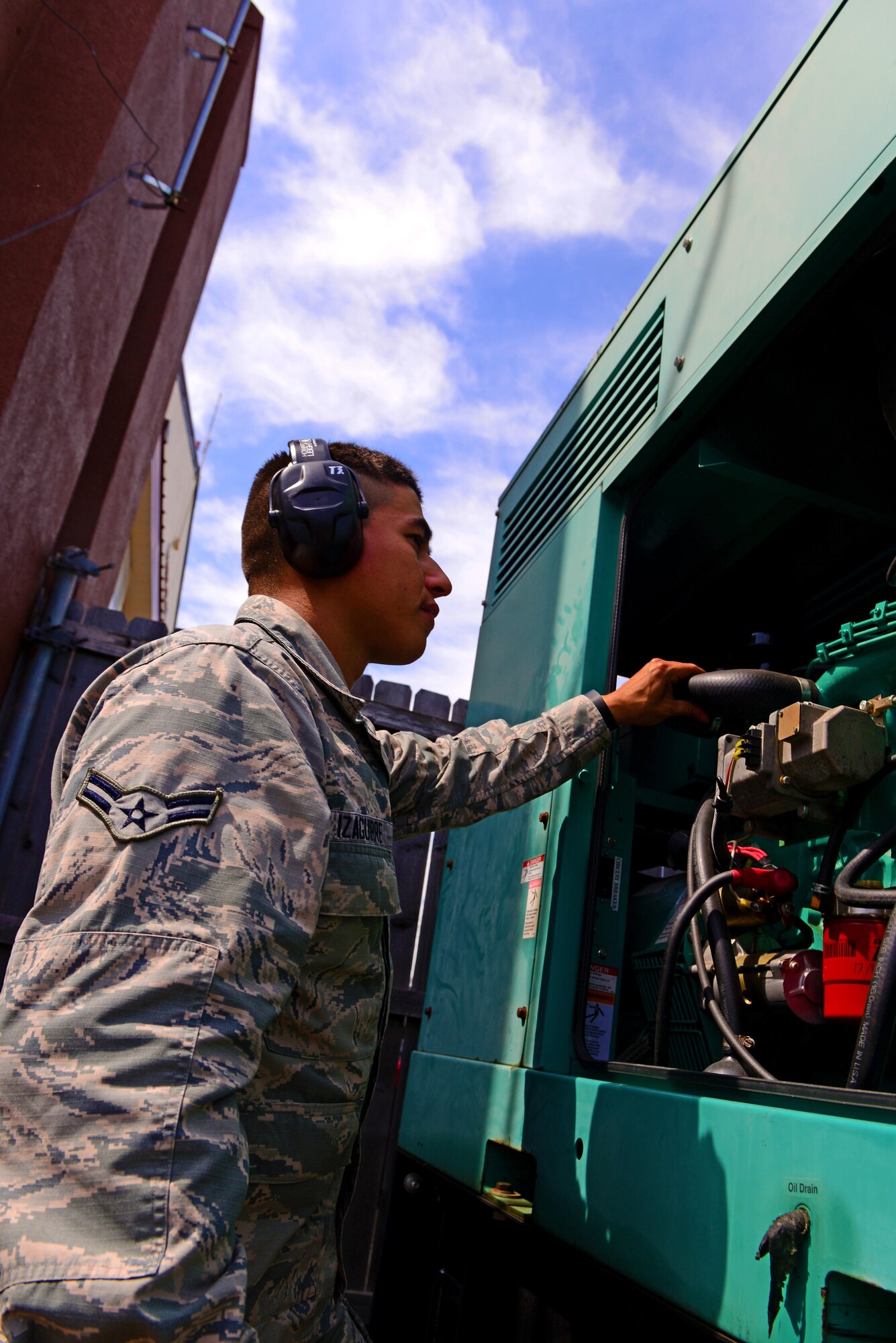 Airman 1st Class Jesus Izaguirre, 2nd Civil Engineer Squadron power production apprentice, examines a generator before performing maintenance at Barksdale Air Force Base, La., March 15, 2016. Generators must receive basic maintenance annually to ensure they continue to run efficiently. (U.S. Air Force photo/Airman 1st Class Luke Hill)