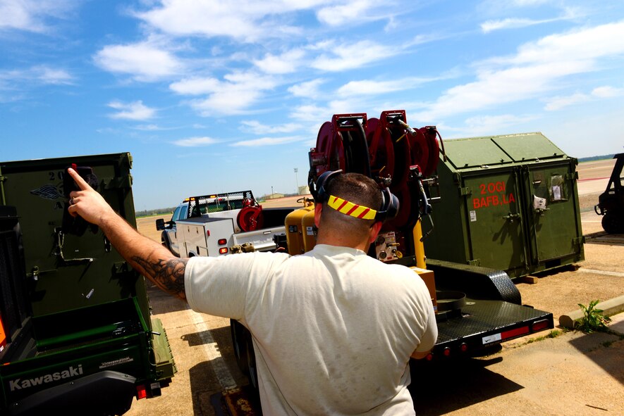 Senior Airman Zachary Shaver, 2nd Civil Engineer Squadron power production journeyman, spots a vehicle and trailer into place at Barksdale Air Force Base, La., March 15, 2016. The trailer contains pumps and vacuums used to do maintenance on generators and allows power production Airmen to do a quicker and cleaner job. (U.S. Air Force photo/Airman 1st Class Luke Hill)