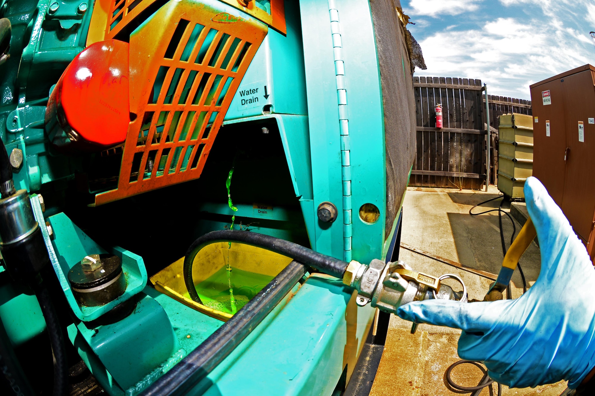 Airman 1st Class Jesus Izaguirre, 2nd Civil Engineer Squadron power production apprentice, vacuums out old coolant fluid from the generator at Barksdale Air Force Base, La., March 15, 2016. The old green coolant was replaced with a new high-performance red coolant which is more durable. (U.S. Air Force photo/Airman 1st Class Luke Hill)