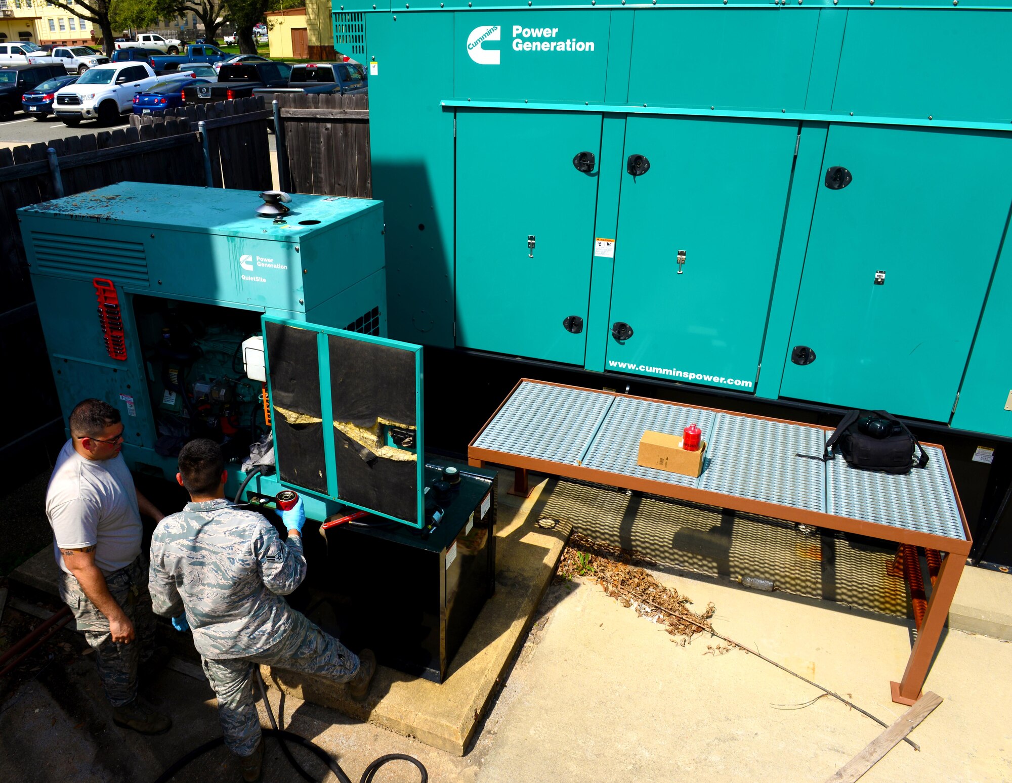 Senior Airman Zachary Shaver , left, and Airman 1st Class Jesus Izaguirre, 2nd Civil Engineer Squadron power production Airmen, perform an oil change on a generator at Barksdale Air Force Base, La., March 15, 2016. Generators are tested each month to ensure they are working correctly in case of a power outage. (U.S. Air Force photo/Airman 1st Class Luke Hill)