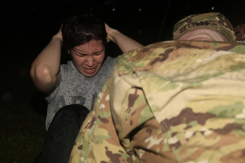 U.S. Army Sgt. Marcy DiOssi of 102nd Division Fort Loenard Wood, performs the situp for the Army Physical Fitness Test event during the Best Warrior Competition (BWC) at Camp Bullis, Texas, March 10, 2016. The BWC is an annual competition to identify the strongest and most well-rounded Soldiers through the accomplishment of physical and mental challenges, as well as basic Soldier skills. (U.S. Army photo by Spc. Darnell Torres).