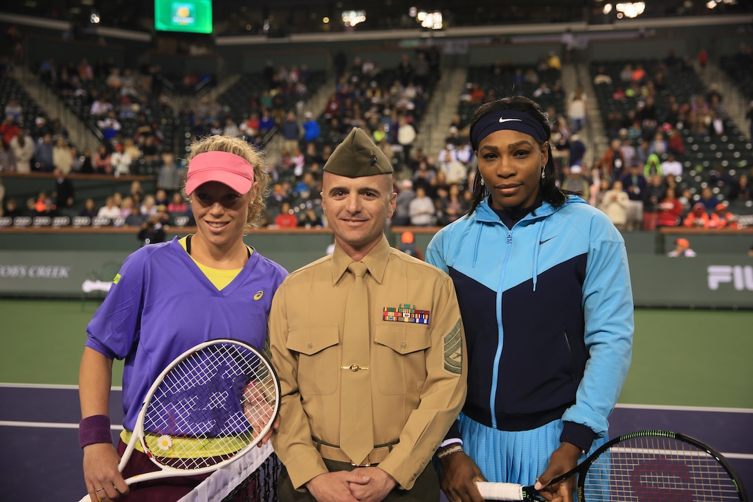 Gunnery Sgt. Antonio Soto, company gunnery sergeant, Marine Corps Communication-Electronics School, stands with Serena Williams and Yulia Putintseva, professional tennis players, prior to their match during the Banque Nationale de Paris Paribas Open at the Indian Wells Tennis Garden in Indian Wells, Calif., March 11, 2016.( Official Marine Corps photo by Cpl. Julio McGraw/Released)
