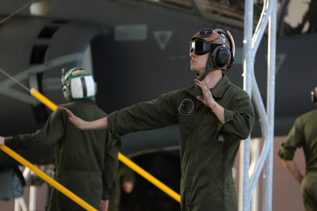 Lance Cpl. Devyn Wildcat directs an TAV-8B Harrier pilot prior to take off at Marine Corps Air Station Cherry Point, N.C., March 11, 2016. A plane captain is responsible for conducting a final examination of the aircraft and guiding the pilots out onto the runway. Plane captains possess extensive knowledge of their designated aircraft and can determine if there are any last minute discrepancies that could potentially ground the aircraft. Wildcat is a plane captain and a fixed-wing aircraft mechanic with Marine Attack Training Squadron 203.  (U.S. Marine Corps photo by Cpl. N.W. Huertas/Released)