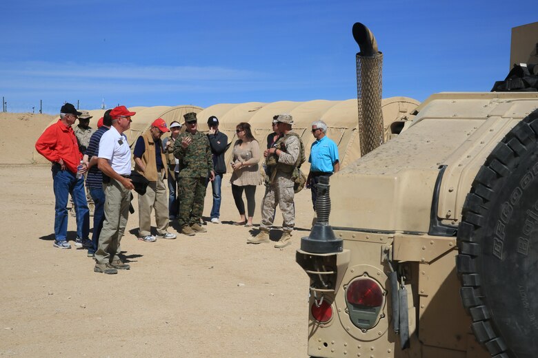 Lieutenant Col. Jared Spurlock, executive officer, 7th Marine Regiment, and Maj. Philip Flambert, company commander, Weapons Company, 2nd Battalion, 7th Marine Regiment, explain the different types of vehicles the Marine Corps utilizes to the tour group during the Palm Desert City Council, Palm Desert Chamber of Commerce and the 1st Marine Division Association, Desert Cities Mitchell Paige Medal of Honor Chapter base tour hosted by 7th Marine Regiment, March 9, 2016. (Official Marine Corps photo by Cpl. Julio McGraw/Released)