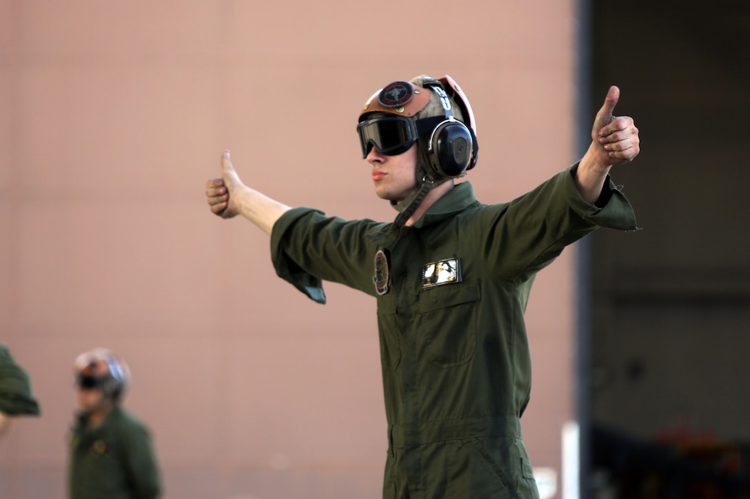 Lance Cpl. Devyn Wildcat directs an TAV-8B Harrier pilot prior to take off at Marine Corps Air Station Cherry Point, N.C., March 11, 2016. A plane captain is responsible for conducting a final examination of the aircraft and guiding the pilots out onto the runway. Plane captains possess extensive knowledge of their designated aircraft and can determine if there are any last minute discrepancies that could potentially ground the aircraft. Wildcat is a plane captain and a fixed-wing aircraft mechanic with Marine Attack Training Squadron 203.  (U.S. Marine Corps photo by Cpl. N.W. Huertas/Released)