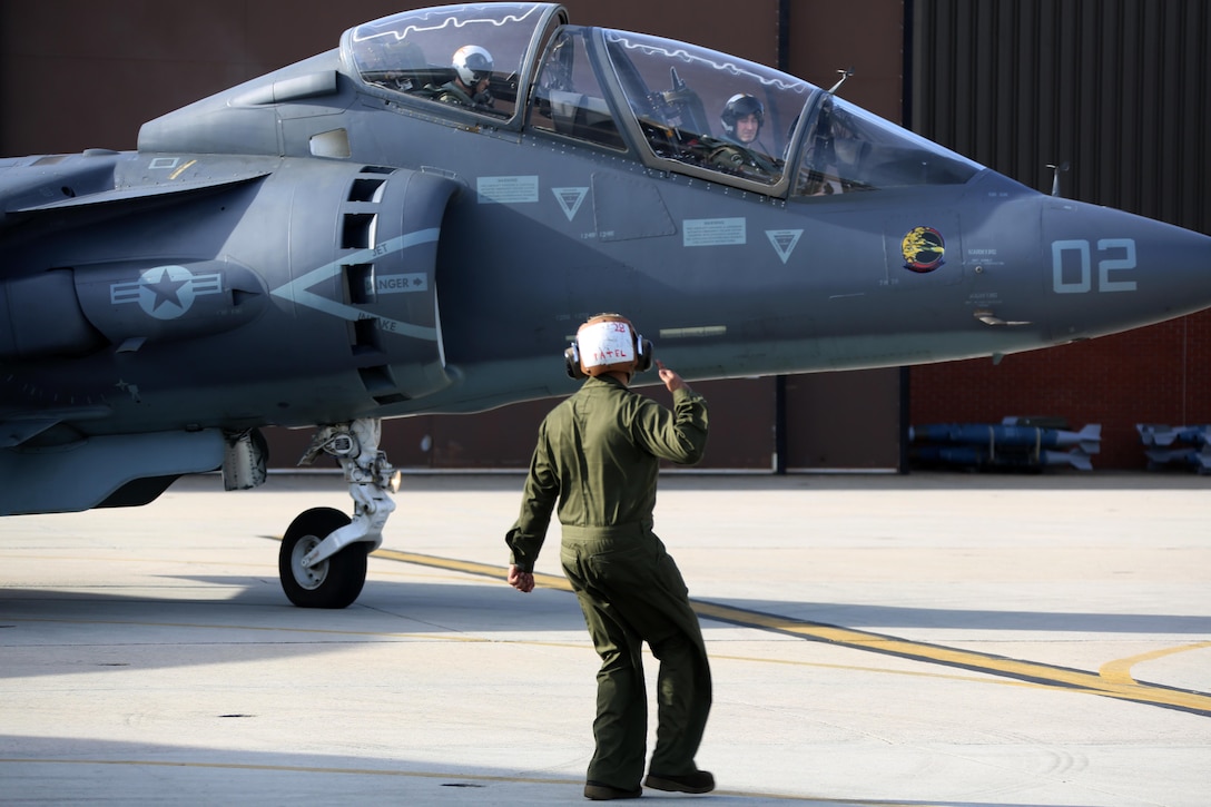 Lance Cpl. Viral Patel directs an TAV-8B Harrier pilot prior to take off at Marine Corps Air Station Cherry Point, N.C., March 11, 2016. A plane captain is responsible for conducting a final examination of the aircraft and guiding the pilots out onto the runway. Plane captains possess extensive knowledge of their designated aircraft and can determine if there are any last minute discrepancies that could potentially ground the aircraft. Patel is a plane captain and a fixed-wing aircraft mechanic with Marine Attack Training Squadron 203. (U.S. Marine Corps photo by Cpl. N.W. Huertas/Released)