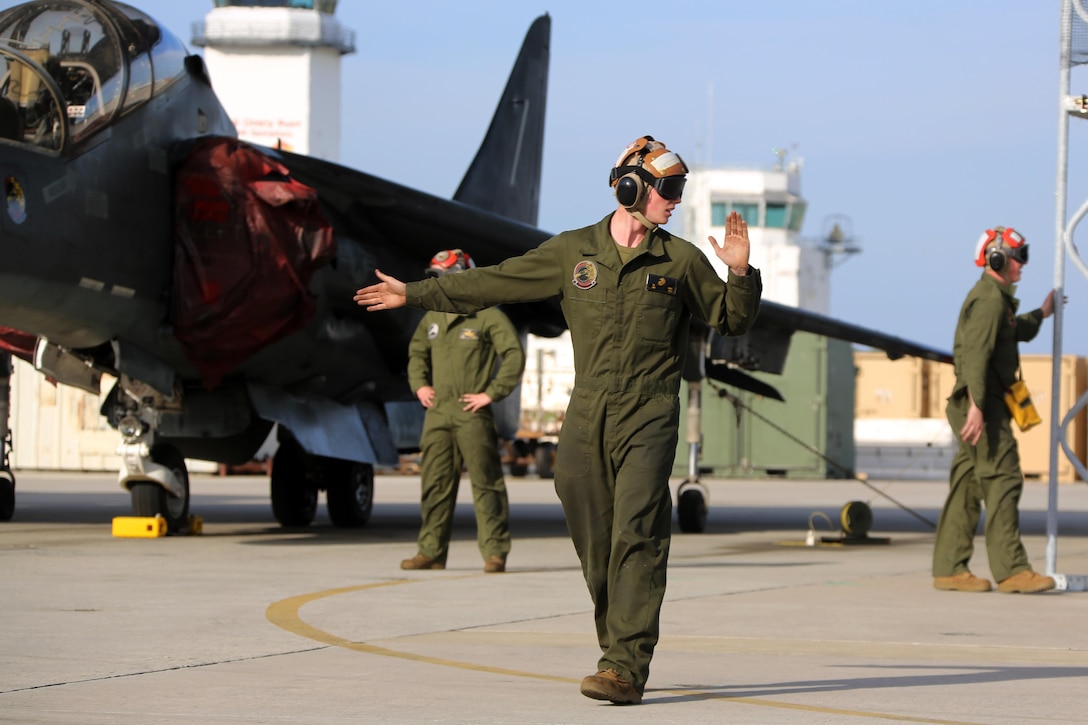 A plane captain directs an TAV-8B Harrier pilot prior to take off at Marine Corps Air Station Cherry Point, N.C., March 11, 2016. A plane captain is responsible for conducting a final examination of the aircraft and guiding the pilots out onto the runway. Plane captains possess extensive knowledge of their designated aircraft and can determine if there are any last minute discrepancies that could potentially ground the aircraft. (U.S. Marine Corps photo by Cpl. N.W. Huertas/ Released)