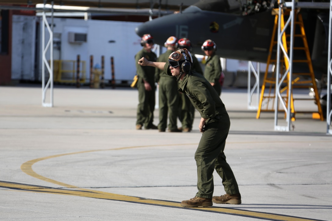 Lance Cpl. Devyn Wildcat directs an TAV-8B Harrier pilot prior to take off at Marine Corps Air Station Cherry Point, N.C., March 11, 2016. A plane captain is responsible for conducting a final examination of the aircraft and guiding the pilots out onto the runway. Plane captains possess extensive knowledge of their designated aircraft and can determine if there are any last minute discrepancies that could potentially ground the aircraft. Wildcat is a plane captain and a fixed-wing aircraft mechanic with Marine Attack Training Squadron 203. (U.S. Marine Corps photo by Cpl. N.W. Huertas/ Released)
