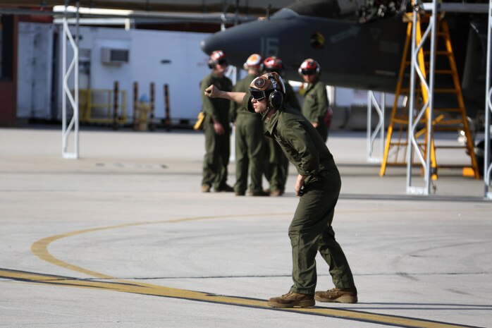 Lance Cpl. Devyn Wildcat directs an TAV-8B Harrier pilot prior to take off at Marine Corps Air Station Cherry Point, N.C., March 11, 2016. A plane captain is responsible for conducting a final examination of the aircraft and guiding the pilots out onto the runway. Plane captains possess extensive knowledge of their designated aircraft and can determine if there are any last minute discrepancies that could potentially ground the aircraft. Wildcat is a plane captain and a fixed-wing aircraft mechanic with Marine Attack Training Squadron 203. (U.S. Marine Corps photo by Cpl. N.W. Huertas/ Released)
