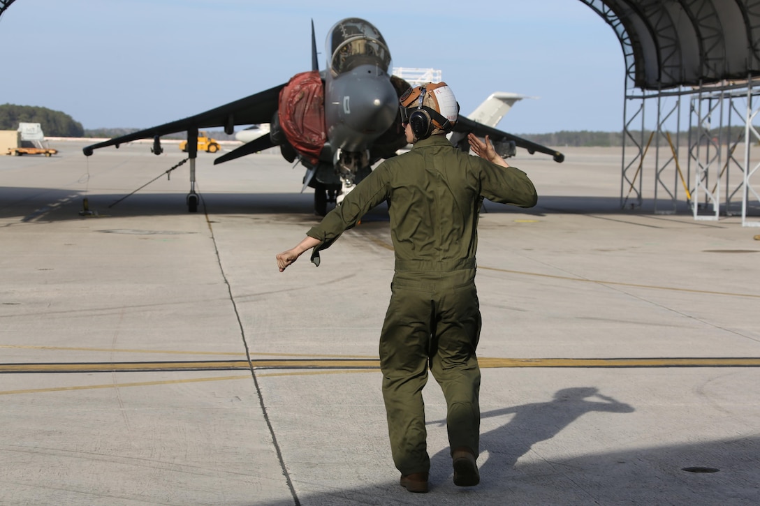 Lance Cpl. Devyn Wildcat directs an TAV-8B Harrier pilot prior to take off at Marine Corps Air Station Cherry Point, N.C., March 11, 2016. A plane captain is responsible for conducting a final examination of the aircraft and guiding the pilots out onto the runway. Plane captains possess extensive knowledge of their designated aircraft and can determine if there are any last minute discrepancies that could potentially ground the aircraft. Wildcat is a plane captain and a fixed-wing aircraft mechanic with Marine Attack Training Squadron 203.  (U.S. Marine Corps photo by Cpl. N.W. Huertas/ Released)