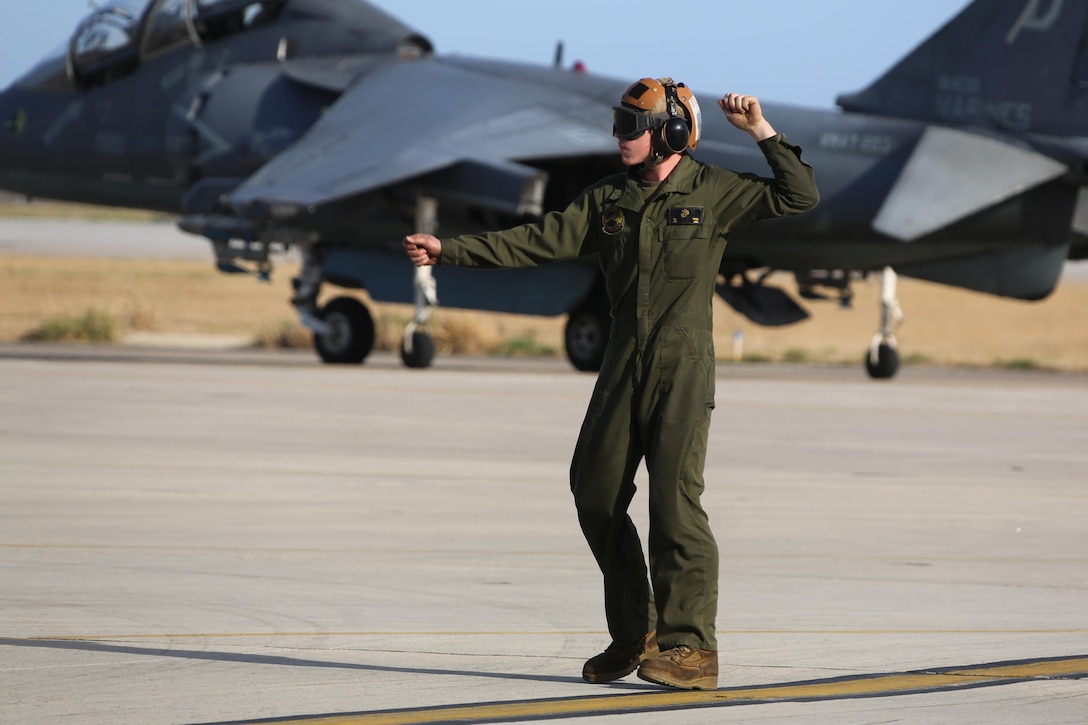 Lance Cpl. Robert Tipton directs an TAV-8B Harrier pilot prior to take off at Marine Corps Air Station Cherry Point, N.C., March 11, 2016. A plane captain is responsible for conducting a final examination of the aircraft and guiding the pilots out onto the runway. Plane captains possess extensive knowledge of their designated aircraft and can determine if there are any last minute discrepancies that could potentially ground the aircraft. Tipton is a plane captain and a fixed-wing aircraft mechanic with Marine Attack Training Squadron 203. (U.S. Marine Corps photo by Cpl. N.W. Huertas/ Released)
