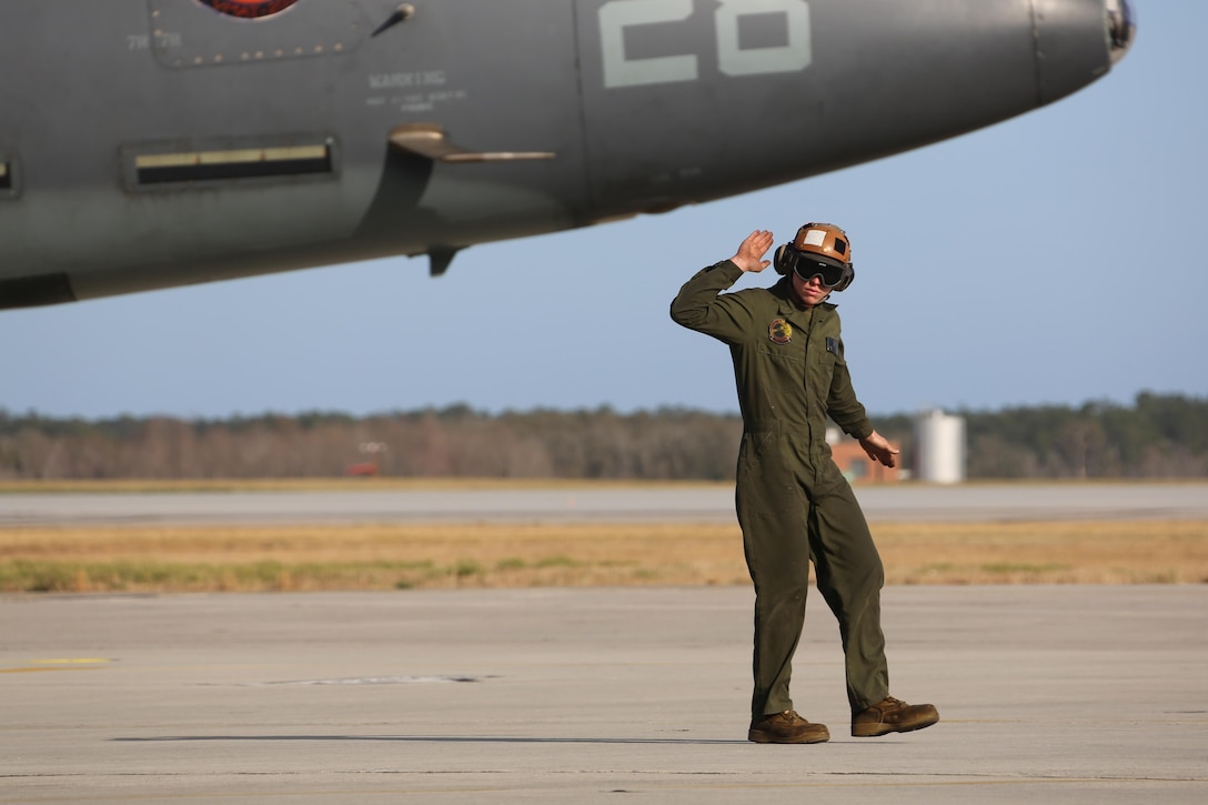 Lance Cpl. Robert Tipton directs an TAV-8B Harrier pilot prior to take off at Marine Corps Air Station Cherry Point, N.C., March 11, 2016. A plane captain is responsible for conducting a final examination of the aircraft and guiding the pilots out onto the runway. Plane captains possess extensive knowledge of their designated aircraft and can determine if there are any last minute discrepancies that could potentially ground the aircraft. Tipton is a plane captain and a fixed-wing aircraft mechanic with Marine Attack Training Squadron 203. (U.S. Marine Corps photo by Cpl. N.W. Huertas/ Released)