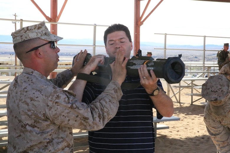 Master Sgt. Henry Rimkus, operations chief, 2nd Battalion, 7th Marine Regiment, shows, Patrick Klein, member, Palm Desert Chamber of Commerce, a decommissioned M136 AT4 Anti-Tank Rocket training tube during the Palm Desert City Council, Palm Desert Chamber of Commerce and the 1st Marine Division Association, Desert Cities Mitchell Paige Medal of Honor Chapter base tour hosted by 7th Marine Regiment March 9, 2016. (Official Marine Corps photo by Cpl. Julio McGraw/Released)