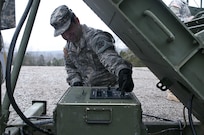 Computer support - U.S. Army Reserve Sgt. Grady Starkey, 369th Engineer Company, and Proctorville, Ohio, tests the Volcano system, a mine distribution system, during the 478th Engineer Battalion's crew-served weapons qualification and field training exercise, March 10 to 13 at Fort Knox, Ky. (U.S. Army photo by Staff Sgt. Debralee Best)