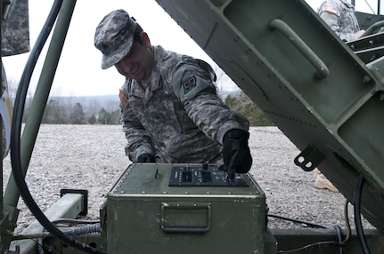 Computer support - U.S. Army Reserve Sgt. Grady Starkey, 369th Engineer Company, and Proctorville, Ohio, tests the Volcano system, a mine distribution system, during the 478th Engineer Battalion's crew-served weapons qualification and field training exercise, March 10 to 13 at Fort Knox, Ky. (U.S. Army photo by Staff Sgt. Debralee Best)