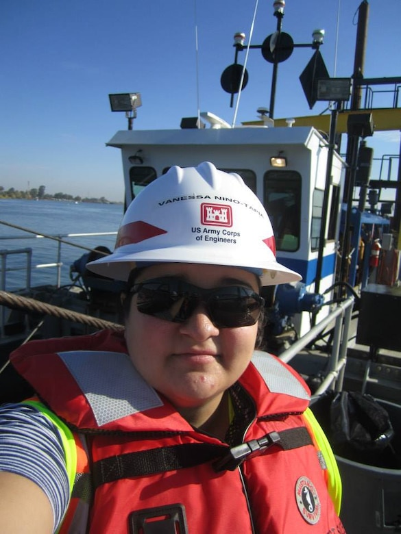 Vanessa Niño-Tapia, civil engineer for the Sacramento District, rides aboard the Sounder, a Corps’ dredging boat, on the Sacramento River near Rio Vista, California, in September 2013 to learn how the topography of the bottom of the channel is mapped and to gain experience on how a dredge operates. Participants in the Recent Graduates Program are given professional career development assignments by rotating through different areas of work within the agency and receive formal training at some of the Corps’ most respected educational centers. (U.S. Army photo / Released)