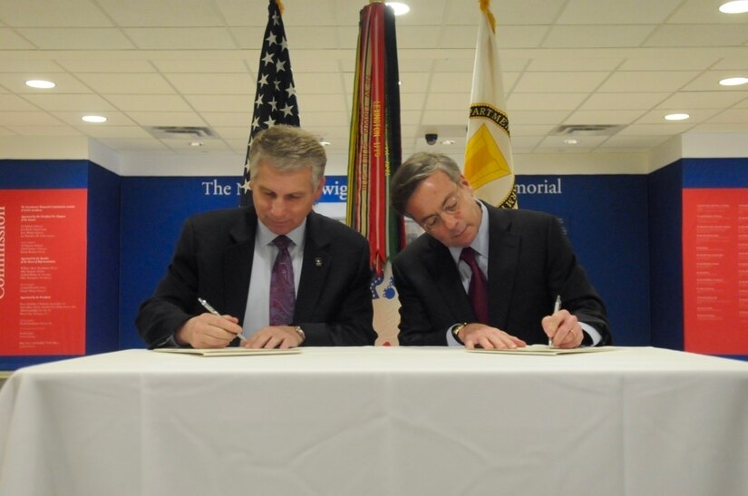Stephen Austin, assistant chief of Army Reserve, and Sidney Goodfriend, founder and chairman of American Corporate Partners, sign a partnership agreement at the Pentagon in Washington March 21. The partnership launched the new Women’s Veteran Mentoring Program initiative. 