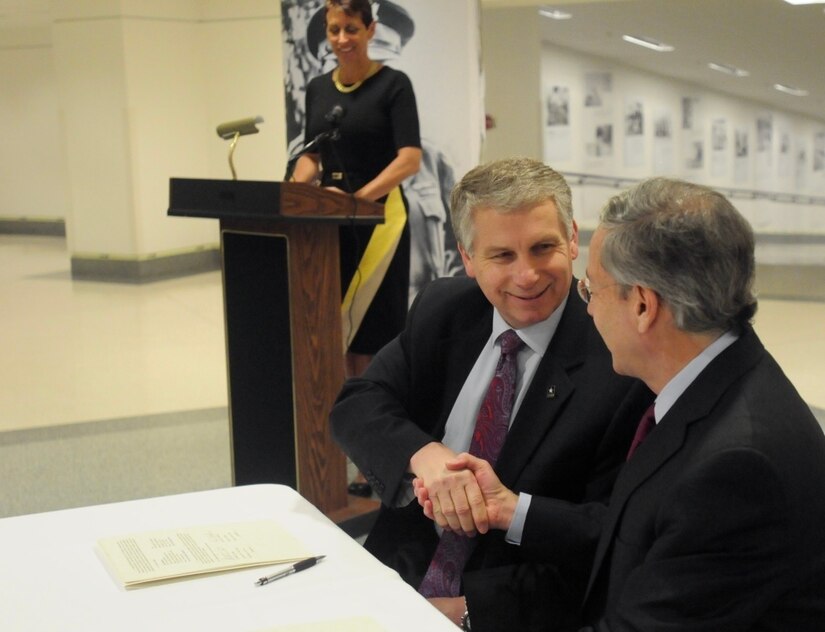 Stephen Austin, assistant chief of Army Reserve, and Sidney Goodfriend, founder and chairman of American Corporate Partners, take a moment to smile after signing a partnership agreement between the USAR and "ACP" during the American Corporate Partners and USAR Partnership Signing at the Pentagon in Washington March 21.