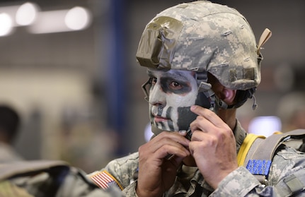 U.S. Army Reserve Capt. Phil Spence, 412th Civil Affairs Battalion civil military operations center chief, fastens his helmet strap prior to a static line jump over Wright-Patterson Air Force Base, Ohio, March 19, 2016. The 412th is an Army Reserve unit out of Columbus, Ohio and is required to complete eight jumps per year to remain current. (U.S. Air Force photo by Wesley Farnsworth/Released)