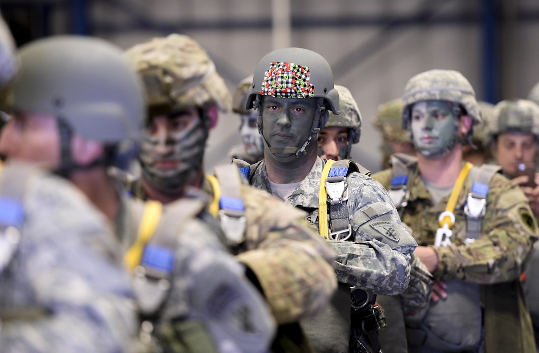 Soldiers with the U.S. Army Reserve 412th Civil Affairs Battalion from Columbus, Ohio, form lines known as “sticks” before walking out to the waiting U.S. Marine Corps KC-130J aircraft to conduct a jump over Wright-Patterson Air Force Base, Ohio, March 19, 2016. This jump was the first in almost 20 years to be conducted at Wright-Patterson by any unit. (U.S. Air Force photo by Wesley Farnsworth/Released)