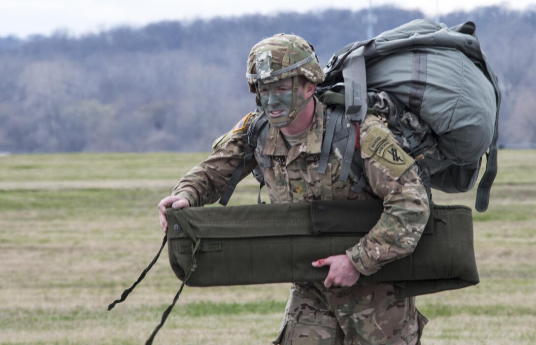 U.S. Army Reserve Maj. Neil Chitwood, 412th Civil Affairs Battalion, C company commander, walks from the flight line infield back to the hangar after completing a successful static line jump at Wright-Patterson Air Force Base, Ohio, after conducting a jump from 1250 feet, March 19, 2016. The soldiers jumped from a KC-130J aircraft from the 252 Marine Aerial Refueler Transport Squadron, Marine Aircraft Group 14, 2nd Marine Aerial Wing, Marine Corps Air Station, Cherry Point, N.C. (U.S. Air Force photo by Wesley Farnsworth / Released)