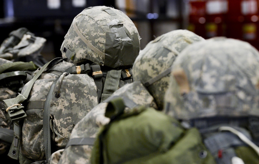 Soldiers gear from the U.S. Army Reserve’s, 412th Civil Affairs Battalion, Columbus, Ohio, lay on the floor in straight lines after a successful static line jump over Wright-Patterson Air Force Base, Ohio, March 19, 2016. This jump was the first in almost 20 years to be conducted at Wright-Patterson by any unit. (U.S. Air Force photo by Wesley Farnsworth / Released)