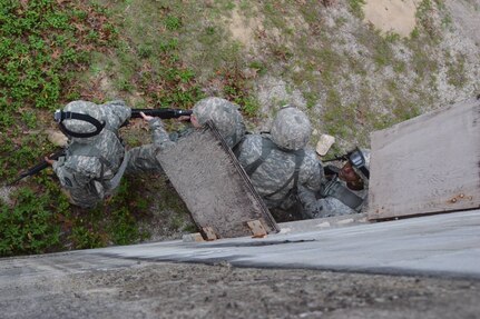 Sgt. Maj. Johnny Wise, noncommissioned officer in charge of the 143rd Sustainment Command (Expeditionary) Best Warrior Competition 2016, briefs the competition rules building clearing team prior to them executing the mission. From left-right: Pfc. Ward (518th Sustainment Brigade, Knightdale, N.C.), Sgt. Davis (321st Sustainment Brigade, Baton Rouge, La.), Sgt. Jones (642nd Regional Support Group, Decatur, Ga.) and Sgt. Meheula (642nd Regional Support Group).