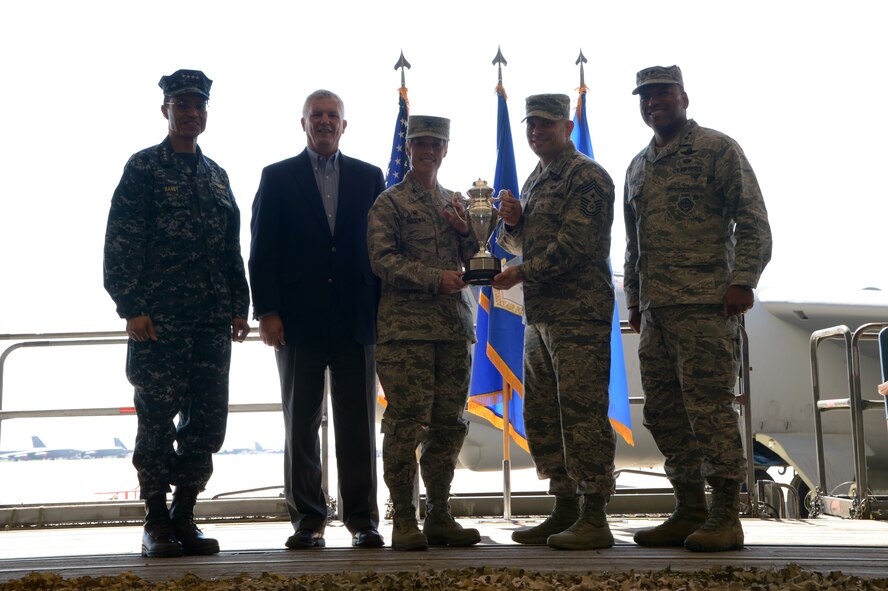 Left to right: U.S. Navy Adm. Cecil D. Haney, U.S. Strategic Command (USSTRATCOM) commander; Mr. W. Gary Gates, Strategic Command Consultation (SCC) Committee member; U.S. Air Force Col. Kristin Goodwin, 2nd Bomb Wing commander; U.S. Air Force Chief Master Sgt. Tommy Mazzone, 2nd Bomb Wing command chief master sergeant; and U.S. Air Force Maj. Gen. Richard M. Clark, USSTRATCOM's Joint Functional Component Command for Global Strike commander; pose for a photo during an award ceremony honoring the 2nd Bomb Wing at Barksdale Air Force Base, La., March 21, 2016. During the ceremony, Haney and Gates presented the 2015 Omaha Trophy, strategic bomber category, to Goodwin and Mazzone in recognition of the 2nd Bomb Wing's contributions to USSTRATCOM's global strategic missions. The Omaha Trophy, which dates back to the U.S. Air Force's Strategic Air Command, was originally created by the SCC in 1971. At the time, a single trophy was presented annually as a token of appreciation to USSTRATCOM's best wing. Since then, the tradition has evolved to unit-level awards that recognize the command's premier intercontinental ballistic missile (ICBM) wing, ballistic missile submarine, strategic bomber wing and global operations (space/cyberspace) unit. This year, a new category was added to include the combatant command's top strategic aircraft wing. (U.S. Air Force photo by Staff Sgt. Joseph A. Pagan Jr.)