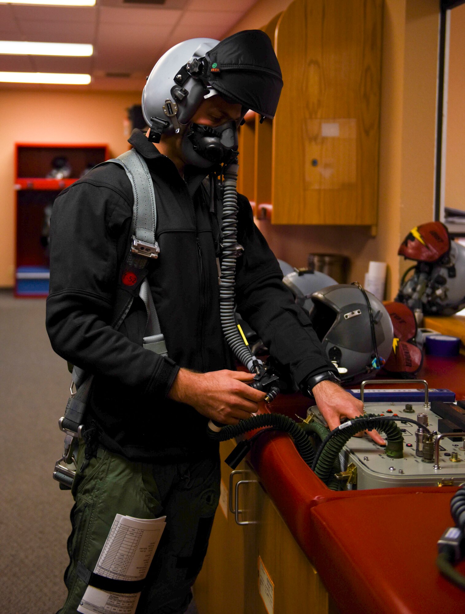 A pilot inspects his helmet before takeoff in the 72-hour sortie surge March 14, 2016, at Mountain Home Air Force Base, Idaho. The purpose of the surge is to provide readiness training. (U.S. Air Force photo by Airman Alaysia Berry/RELEASED)