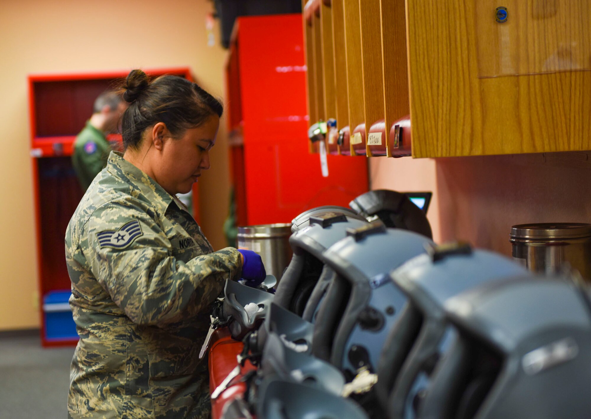 Staff Sgt. Anna North, 366th Operations Support Squadron aircrew flight equipment journeyman, cleans helmets at Mountain Home Air Force Base, Idaho. Airmen from Aircrew Flight Equipment are responsible for inspecting flight equipment such as protective clothing, flotation equipment, emergency evacuation systems and parachutes. (U.S. Air Force photo by Airman Alaysia Berry/RELEASED)
